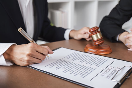 Businessman and lawyer discussing business contract document for legal advice in lawyers office.