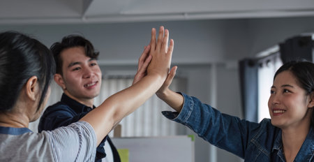 Asain business team Happy to be successful partnership teamwork achieved the desired goal.の写真素材