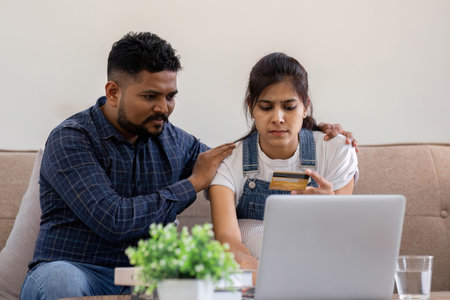 A young couple is stressed over credit card charges used for online purchases.の写真素材