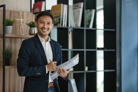 Portrait of a young businessman with work documents Successful businessman managing business documents.の写真素材