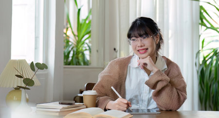 Asian female student studying online, studying on a video call, zoom call, passionate Asian female teacher learning English online with a laptop computerの写真素材