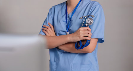 Close up a doctor standing with his arms crossed holding a stethoscope, a doctor from the hospital. Medical staff people. Team of doctor and nurse in hospital. Concept Of Medicalの写真素材