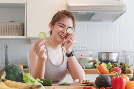 Sporty young woman is preparing healthy food on light kitchen. healthy food concept.の写真素材