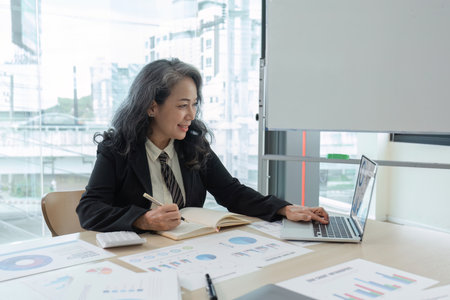 Business woman using calculator for do math finance on wooden desk in office and business working...