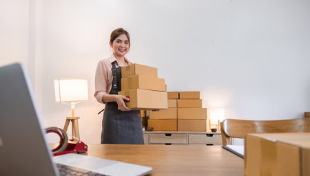 Portrait of starting a small business SME business owner Female entrepreneur working on merchandise...