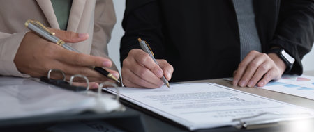 Close-up of the agreement document being signed. Business contract of young businesswomanの写真素材