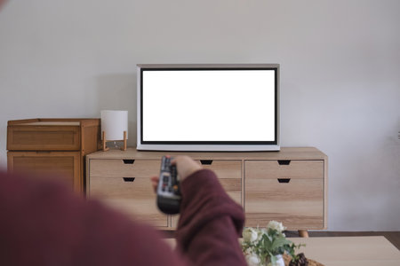 Young beautiful Asian woman is watching a fun movie on television at home. Attractive casual girl...