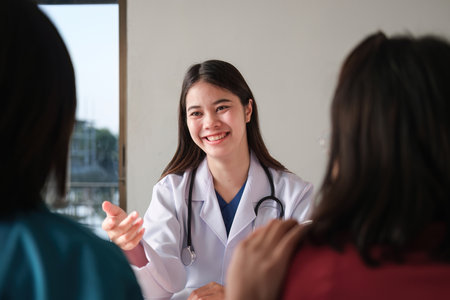 An Asian female doctor is consulting a patient who comes to discuss taking medication for health care. and treat disease with medicineの写真素材