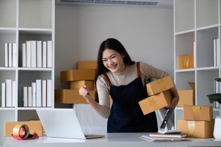 Startup small business entrepreneur SME, asian woman packing cloth in box. Portrait young Asian...