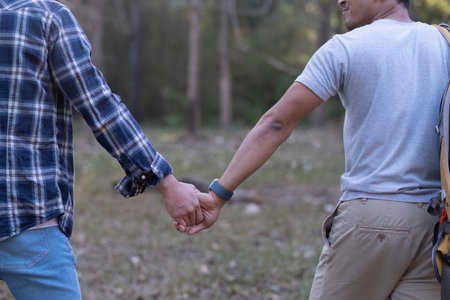 Asian LGBTQ couple. Rear view of gay couple walking together and holding hands.