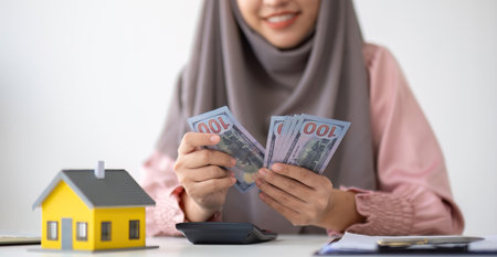 Muslim businesswoman dealing with real estate, buying and selling houses and insurance for real...