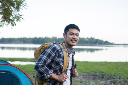 Asian tourist smiling happily Backpacker, hiking trips, outdoor activities on vacation.の写真素材