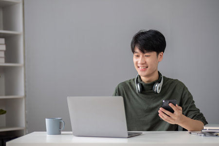 Portrait of a handsome young office worker intently studying how to do a presentation project on a...
