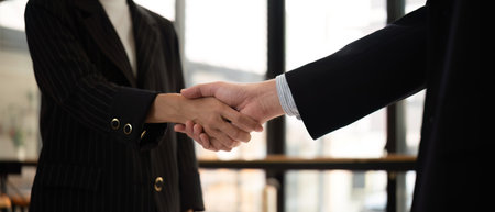 Businessmen shake hands after a meeting, congratulating colleagues and reaching a business...