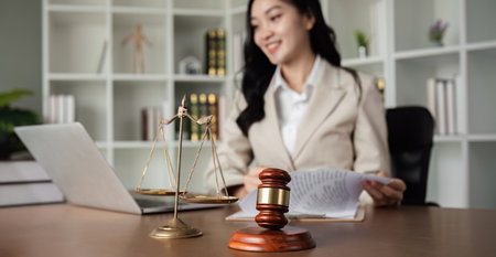 A female Asian lawyer reviews business and real estate laws. Legal consultants provide legal advice...