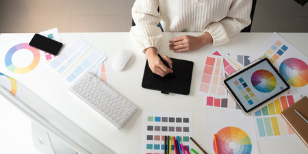 Top view of designer working in graphic design Choose colors for working with your computer at your desk.の写真素材