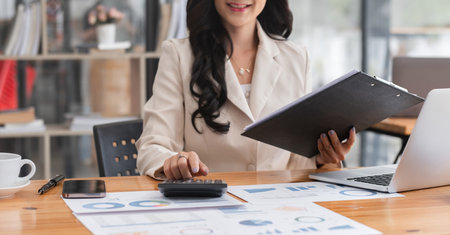 Close-up view of Asian businesswoman working online and planning financial calculation data working...