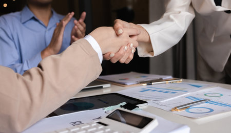 Successful negotiation, handshake, two businessmen shaking hands with partners to celebrate...