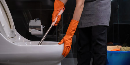 Happy young housewife cleaning the bathtub Use a bath towel to clean the bathtub.の写真素材