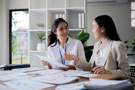 Team businesswomen discussing financial reports in office