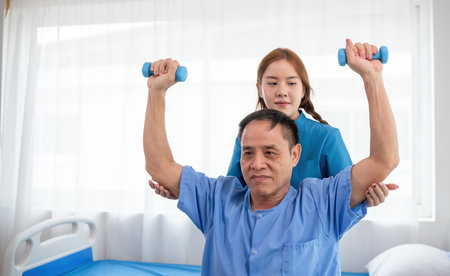 Young Caregiver assistance Elderly Sick Person with Physical Therapy Exercises in a Bright, Modern...