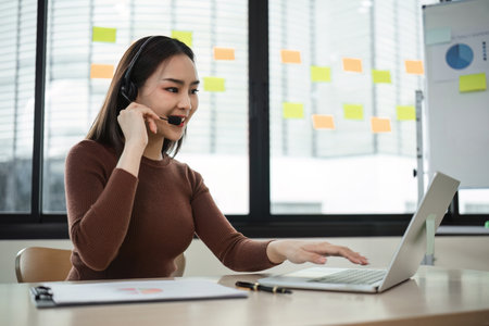 Professional Call Center Woman Using Headset and Laptop in Modern Office Environment