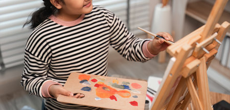 Young Girl Painting with Acrylics on Canvas in a Bright Studio - Creative Art and Childhood Expressionの写真素材