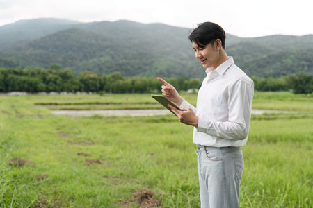 Agricultural Researcher Using Tablet Technology in Field for Modern Farming and Data Analysis