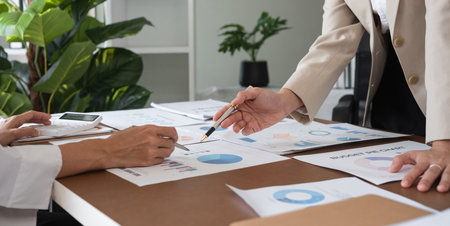 Team of Accountant Collaborating and Sharing Ideas in a Modern Office Environment with Financial...