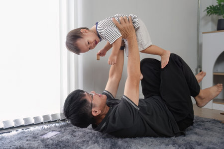 Father and Son Enjoy Quality Time Together at Home, Bonding and Playing in a Cozy Living Room...