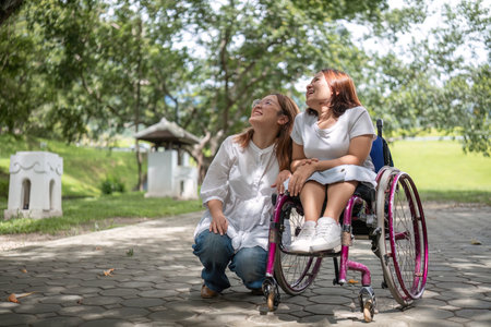 Young Disabled Woman in Wheelchair and Best Friend Enjoying a Relaxing Day in the Park