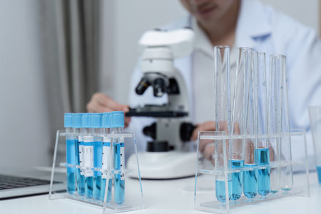 Researchers Conducting Medical Drug Research in Laboratory with Microscope and Test Tubes