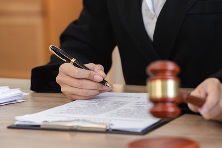 Female Lawyer Reviewing Legal Documents for Lawsuit in Modern Office Setting