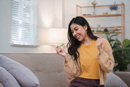 Excited Woman Checking Pregnancy Test Results at Home in a Cozy Living Room Setting