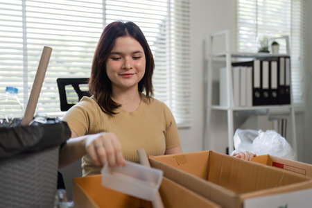 Woman Engaged in Eco-Friendly Activity by Collecting Plastic Waste for Recycling in a Modern Office...