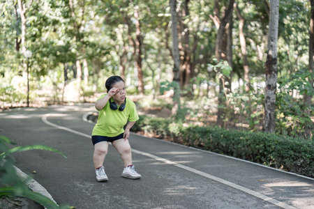 Empowered Young Woman with Disability Jogging in Park for Fitness and Wellbeingの写真素材
