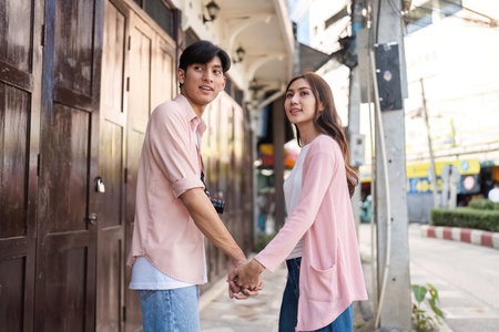 Valentines day celebration urban street couple holding hands vibrant atmosphere romantic viewpoint love conceptの写真素材
