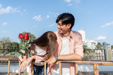 Valentines day celebration with roses outdoor park couple enjoying love bright day romantic conceptの写真素材