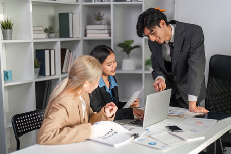 Diverse Business Team Collaborating on Project Strategy in Modern Office Environmentの写真素材
