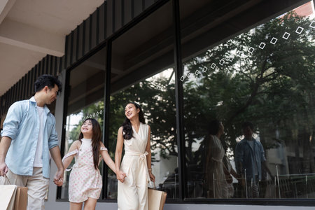 Joyful Family Shopping Experience Parents and Child Enjoying a Day Out with Shopping Bagsの写真素材