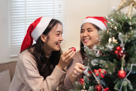 Young Woman Joyfully Decorates Her Room for a Cozy Christmas Celebration Filled with Love and...