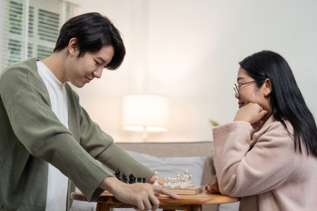 Mother and Son Enjoy Quality Time Playing Chess Together in Cozy Living Room Settingの写真素材