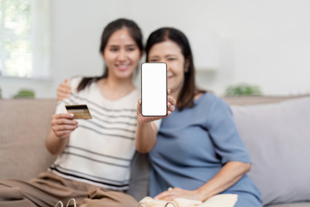 Mother and Child Shopping Online with Smartphone App - Modern Family Lifestyle and E-commerce Conceptの写真素材