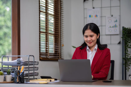 Happy business woman sitting and talking at work Job interview in front of laptop at home officeの写真素材