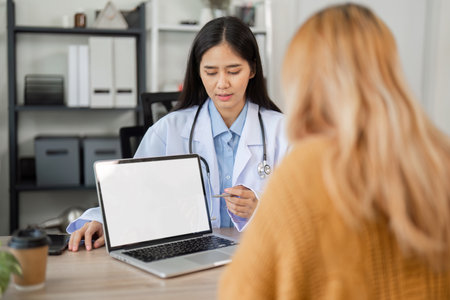 Female Doctor Providing Health Advice and Medicine Guidance in a Professional Medical Consultation Settingの写真素材