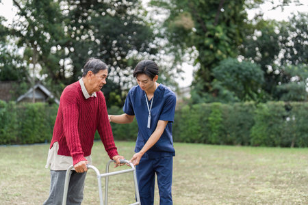 Nurse assisting elderly man with walker in a lush garden, fostering trust and support