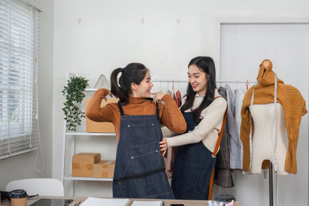 Creative fashion designers collaborating on garment creation in a trendy studio