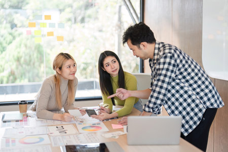 Diverse team discussing design concepts and collaborating in a modern office.