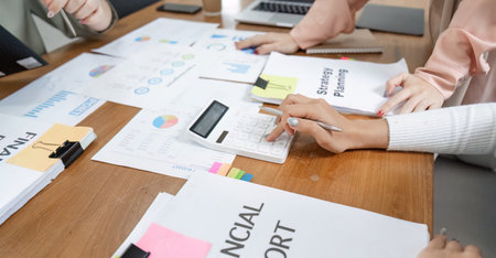 Team of professionals analyzing financial reports and strategies in a collaborative office...