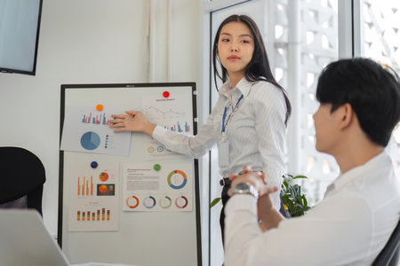 Confident woman explaining data insights in a team meeting